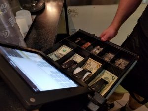 View of the cash drawer and the iPad Wilkins uses with the ShopKeep app.