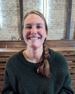 Close up shot of Haley with a big smile. She has rosy cheeks and blond hair woven into a thick braid.