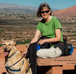 Sara Streeter and her yellow lab mix on a bench in desert country.