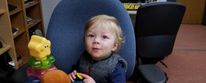 Two-year-old boy presses button to activate toy.