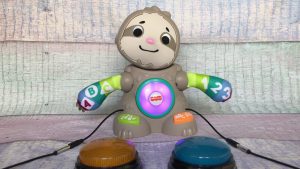 Light-up sloth toy with two switches attached